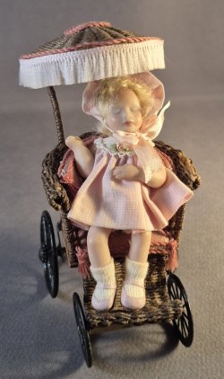 Sleeping toddler in wicker carriage
