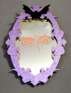Spooky face in mirror, oval, one inch scale